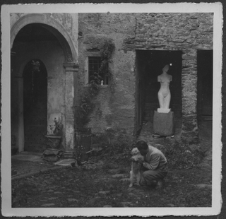 Mario Bernasconi con il cane davanti alla propria casa