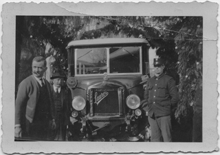 Tre uomini davanti ad un'automobile