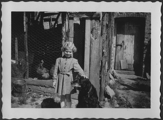 Giuseppina Storni con cane accanto a un pollaio