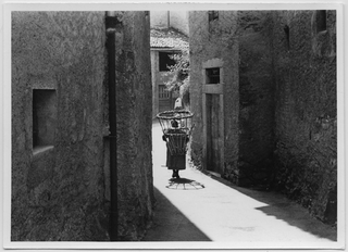 Teresa Antonini con la gerla nel nucleo di Lugaggia